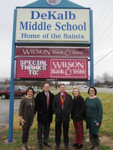 DeKalb County Middle School recently honored Wilson Bank & Trust for providing the school with a new digital message board. WBT Smithville Office Manager Chad Colwell, second from left, joined school officials (L to R) Anita Puckett, Patrick Cripps, Lacey Foutch and Suzette Barnes in dedicating the new sign, which can display customized messages and images.