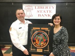 Rhonda Caplinger (right) presents the Liberty State Bank Officer of the Year Award of the DeKalb County Volunteer Fire Department to Lieutenant Dusty Johnson during Saturday night’s annual awards dinner. Johnson also won the award in 2018