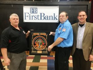 Casey Midgett (right) presents the First Bank Station of the Year Award of the DeKalb County Volunteer Fire Department to Shawn Puckett (left) and Station Commander Calvin Tramel of the new Four Seasons Station during Saturday night’s annual awards dinner.