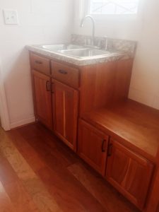 Tiny House kitchen sink and solid wood cherry cabinets