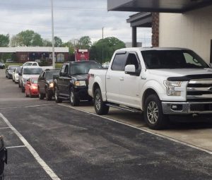 Customers lined up at drive through window of County Clerk Wednesday