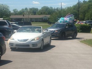 Long procession drives by the Webb House Retirement Center Sunday to surprise resident Billie Robinson there on her 100th birthday