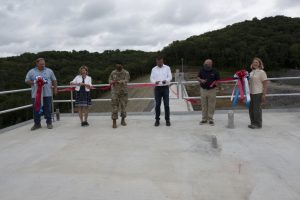 (Left to Right) Bill DeBruyn, U.S. Army Corps of Engineers Nashville District construction liaison; Tennessee District 40 Rep. Terri Lynn Weaver; Lt. Col. Sonny Avichal, Nashville District commander; Steve Kohler, president and chief executive officer of Thalle Construction Corporation; David W. Salyers, P.E., Commissioner of Tennessee Department of Environment and Conservation; and Linda Adcock, Corps of Engineers retiree and former project manager; cut a ribbon signifying the completion of the roller compacted concrete berm and the overarching Center Hill Dam Safety Rehabilitation Project. (USACE Photo by Lee Roberts)