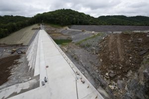 Officials held a ceremony July 1, 2020 to celebrate the completion of the last phase of repairs for the $353 million Center Hill Dam Safety Rehabilitation Project. The U.S. Army Corps of Engineers Nashville District recently finished constructing a roller compacted concrete berm to reinforce the auxiliary dam at Center Hill Lake, a secondary earthen embankment that fills a low area in the landscape just east of the main dam. Construction of the $50 million RCC Berm completes the final major construction contract to remediate the Center Hill project. (USACE Photo by Lee Roberts)