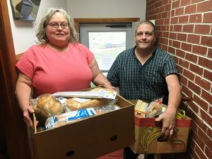Snow Hill Baptist Church carries on 20 year mission to feed the needy. Snow Hill Baptist Church member Patty Hale and Pastor Todd Pack preparing food boxes for church food ministry distribution