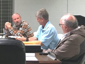 City leaders and the contractor are seeking common ground on a plan to resume construction of the new Smithville Police Department building. Mike Boyce of Boyce Ballard Construction of Murfreesboro, contractor for the project (pictured left) listens as the city’s architect, Wayne Oakley of Studio Oakley Architects of Lebanon (center) makes a point during Thursday night’s meeting of the Smithville Mayor and Aldermen. City Attorney Vester Parsley (right) looks on during the discussion.