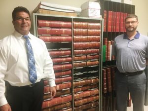 More than 138 years of county commission meeting minutes are currently stored in the archives of the clerk’s office and up until now they have remained in their original paper forms, bound in books as shown here with County Clerk James L. (Jimmy) Poss (left) and Aaron Greer (right) of Business Information System, a company that offers software solutions to local governments. Images of these minutes have all been scanned, saved and are currently being uploaded to a web-based server where they will soon become available online for public viewing and printing, possibly by the end of next week.