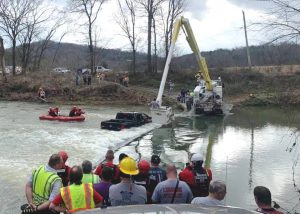 Swift creek waters Sunday, February 28 swept a pickup truck off Odom Page Road (Preston-Vickers Road) at Liberty. Five people, including a 16 month old child, were trapped in their truck until help arrived. (Photo by DeKalb Fire Department)