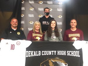 DCHS Lady Tiger Soccer Star Carly Vance Signed with Freed-Hardeman accompanied by her parents seated next to her Cheryl and Chris Vance, Freed-Hardeman Assistant Coach Luke Janiec (standing) and DCHS Lady Tiger Soccer Coach Dylan Kleparek (Coach K) seated far left.