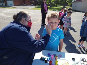 Smithville Elementary Celebrates Fun Day. Mrs. Carol painting Knox Cantrell's face