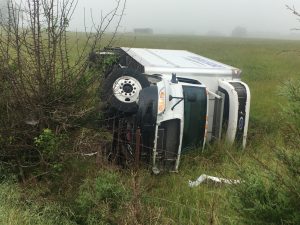 Truck Driver Escapes Injury in Rollover Crash