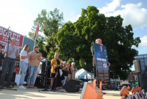 Darrin Vincent shows off his “Tennessee Music Pathways” marker to the Fiddlers Jamboree crowd Saturday after the unveiling. The marker, honoring Vincent’s musical contributions, will be placed on the square in Smithville. Vincent’s wife, children, mother and other family members and friends joined him on stage for the unveiling.