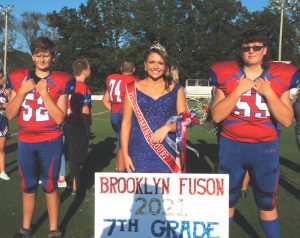 7th grade DeKalb Middle School attendant Brooklyn Fuson. She was escorted by Turner Bryant (left) and Bryson Arnold (right)