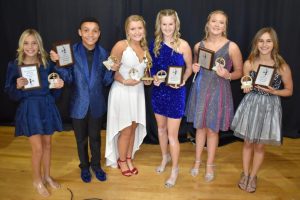 The stars of the DeKalb Saints Football and Cheerleading programs came out Monday night for the annual awards banquet held at the First Baptist Church Life Enrichment Center. Pictured from left are Best Stunts winner Khloe Grandstaff, Best Jumps winner Landen Tubbs, Most Valuable Cheerleader Deanna Agee, Outstanding Leadership winner Brooklynn Blaylock, Most Spirited award winner Lillie Young, and Most Improved Jaycee Daley. (Chris Tramel Photo)