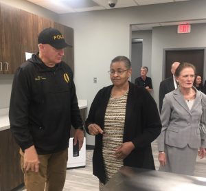 Smithville Police Chief Mark Collins welcomes Annette Evans during Open House of the new Smithville Police Department Building Sunday. Guylene Atnip pictured right