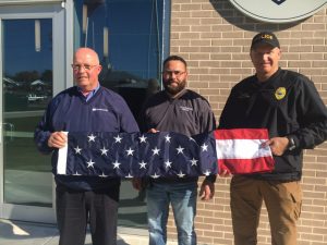 Woodmen Life representative Tim Bumbalough supplied the Smithville Police Department Friday with new United States and Tennessee State flags to fly outside and for display inside the building. Receiving the flags for the police department were Police Chief Mark Collins and Mayor Josh Miller.