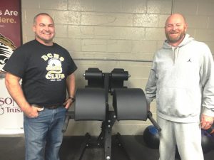 DCHS Tiger & Lady Tiger Soccer Coach Dylan Kleparek (left) and Lady Tiger Basketball Coach and Tigerette Softball Coach Danny Fish (right) show off some of the new weight room equipment for their athletic programs thanks to the support of Wilson Bank & Trust