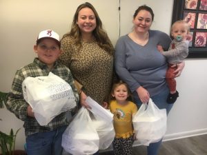 Pictured left to right: Levi, Jessica, and Addi Kate Nixon with Hannah Ball and Walker Pulley were among dozens of volunteers who made deliveries of Thanksgiving Day meals to the needy and underserved Thursday morning on behalf of the DeKalb Emergency Services Association.