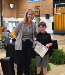 Karson Mullinax poses with Principal Sabrina Farler in recognition of his Perfect Attendance Award.