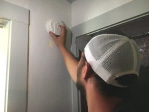 DeKalb Firefighter Blake Reffue installs smoke alarm at the home of Clay and Sharon Farler in Smithville Saturday as part of a “Smoke Alarm Installation Blitz” across DeKalb County by the DCFD and American Red Cross