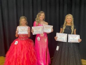 Miss Jamboree in the 11-13 age division: In the 11-13 year old age division 11 year old Ella Grace Kirksey (right) was the winner and also named Most Photogenic along with receiving the award for Prettiest Hair. She is the daughter of Graden and Sabrina Kirksey of Smithville. 12 year old Brileigh Nicole Bullard (center), daughter of Nikki and Jimmy Martin and Riley and Kayla Bullard of Smithville took second place and was awarded for Prettiest Eyes and Attire. Kenli Faith Fish (left), 11-year-old daughter of Tiffany Pedigo and Cody Fish of Smithville received the People’s Choice Award.