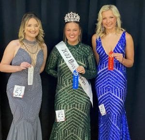 Alexis Grace Atnip (center), daughter of Veronica and Gary Johnson of Smithville, was crowned the 2022 Miss Jamboree in the age 17-20 category Saturday at the county complex auditorium. Finishing in second place was 18 year old Madelyn Mundt (right), daughter of Todd and Kelli Mundt of Knoxville. Caitlin Elisabeth Washer (left) received third place. She is the daughter of John and Karey Washer and Charlise Childers Washer of Smithville.