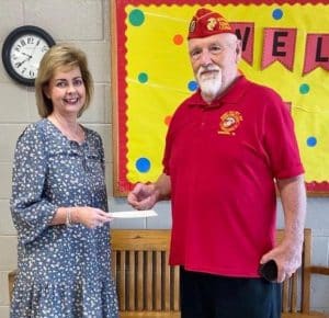 Photo: Lori Poss of Smithville Elementary School accepted a $200 donation from John Hummer of the Bobby Ray Detachment 1377 of the Marine Corps League.