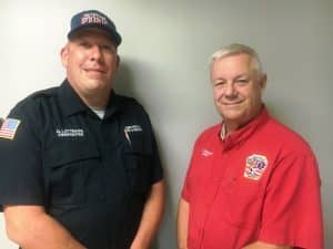 Smithville Fire Chief Charlie Parker (right) congratulates Glen Lattimore upon being hired to fill the department's newly created full-time firefighter position