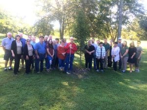 The DeKalb County Soil Conservation District paid tribute to the late Anita Houk Wednesday morning by planting a Sunset Maple tree in her memory at Green Brook Park. Pictured left to right are co-workers, family, and friends: Genrose Davis, Judy Sandlin, Tommy Melton, Taylor Patterson, Mary Melton, Bernard Houk, Jennifer Winchester, Delilah Barrett, Donnell Poss, Melissa Oliver, Tara Hale, and Judy Alsup. Back row: Jimmy Womack, Jimmy Herndon, Zach Fuson, Gene Robinson, Danny Curtis, Donny Green, Deborah Agee, Linda Robinson, Shawn Rice, Jason Winchester, Andria Graham, Sonny Barrett, Pamela Hale, and Justin Winchester.