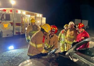 Members of the DCFD’s Citizens Fire Academy become real cutups learning how to use the jaws of life extrication tools on a car. (Photo provided by DeKalb Volunteer Fire Department)