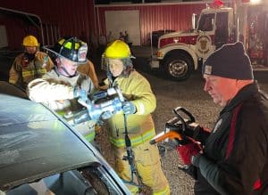 Members of the DCFD’s Citizens Fire Academy learn jaws of life extrication techniques from DeKalb County Firefighters. (Photo provided by DeKalb Volunteer Fire Department)