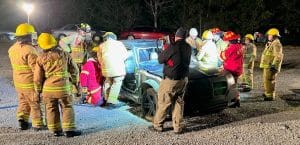 DeKalb County Volunteer Firefighters teach members of the DCFD’s Citizens Fire Academy how to use the jaws of life extrication tools on a car. (Photo provided by DeKalb Volunteer Fire Department)