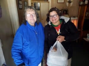 Jamie Blosie (right) delivers Christmas Eve meal to Louise Smith on behalf of the DeKalb Emergency Services Association