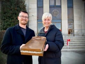 Courthouse Time Capsule Found Revealing Half Century Old Treasures. Pictured County Mayor Matt Adcock with Chamber Director Suzanne Williams holding Time Capsule