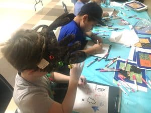 Kids leaving their mark and artwork for quilt squares to make quilts for those in need