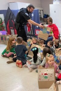 Children at the Smithville Head Start Center last month were treated to bags of gifts thanks to the Smithville Police Department’s “Cops4Kids” program. Officer Lane Ball shown here presenting gift bags to kids