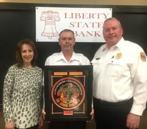 Lieutenant Dusty Johnson (center) received the 2022 Liberty State Bank Officer of the Year Award Saturday night during the annual DeKalb Fire Department awards program. Johnson received the award from Monica Reynolds of Liberty State Bank (left) and DeKalb Fire Chief Donny Green (right)