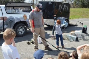 Career Day at DeKalb West School. Jared Randolph, Owner of Centerstone Pest and Wildlife Pros, playfully snares Kindergarten student Keaton Hale.