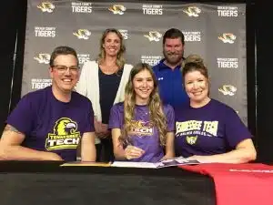 A DCHS high jumper is about to take a big leap to the college ranks. Ally Beneke, 19 year old senior and daughter of Jerry and Kim Beneke, made her commitment to Tennessee Tech official during a brief signing event Tuesday at DCHS. She is pictured here seated with her parents while standing behind her is Track and Field Coaches Kristen VanVranken (Assistant) and Head Coach Jeremy Wilhelm