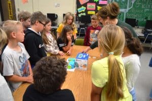 DWS Computer Teacher Lori Vandergriff instructs students from Missy Sliger's 3rd grade homeroom on how to create a computer code for the Botley coding robots to maneuver.