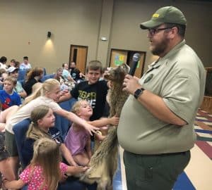 Brad Halfacre, Park Manager at Edgar Evins State Park showed off and let kids get a feel for fur pelt hides from various wildlife mammals including a groundhog, gray and red squirrels and foxes, deer, elk, bobcat, coyote, skunk, black bear, raccoon, cougar and others during Thursday’s Justin Potter and Alexandria Library Summer Reading Program event at the county complex auditorium . Halfacre also shared interesting facts and information about the animals