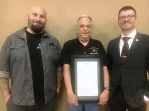 The DeKalb County Commission Monday night adopted a resolution recognizing Administrator of Elections Dennis Stanley (pictured center) on his fourteen years of service to the county in that position. Stanley is stepping down in a few days to begin retirement. The resolution was read during the meeting by the Chairman of the DeKalb County Election Commission, Brandon Gay (pictured left). County Mayor Matt Adcock is pictured right