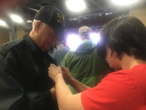 DCHS Band and Chorus students were given pins to present to veterans in the audience in honor of their service during Friday’s Veterans Day program. Band member Jayden Wildes shown here pinning Veteran Billy Adcock.