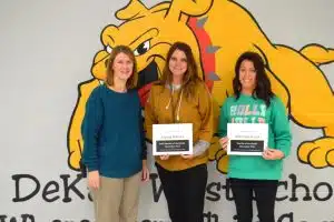 Principal Sabrina Farler presents certificates to Staff of the Month Alyssa Harvey and Teacher of the Month Whitney Brelje.