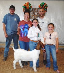 Junior Goat Show Champion! Andrea Kate Estes of Smithville was a big winner in the Junior Goat Show at the DeKalb County Fair Thursday evening. Estes won for Junior Showmanship and the Doe Kid Division as well as the Overall Doe Kid and Yearling Doe Grand Championship. Andrea is pictured here with her family and winning Yearling Doe entry: (Left to right) Carl Paris, Emily Estes, Andrea Estes, Andy Estes, and Caroline Estes