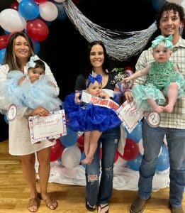 Jamboree Pageant: Winners in the girls 7-12 months group: Queen Sawyer Grace Dalton (pictured center), 9-month-old daughter of Fletcher and Liz Dalton of Sparta. She also received honors for Prettiest Eyes, Attire, Smile, and People’s Choice. First runner-up-Willow May Stanley (pictured right), 8-month-old daughter of Daniel and Jayde Stanley of Smithville. Augusta Lee Hendrix (pictured left) received second runner-up. She is the 7-month-old daughter of Ali Hendrix of Smithville.