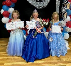 Miss Jamboree Pageant: Winners in the 7–10-year-old age group: Queen Stella Grace Adcock (pictured center), the 9-year-old daughter of Byron and Paige Adcock of Smithville. Stella was also awarded for Prettiest Attire. Haddeigh Grace Harvey (pictured right) was first runner-up. She is the 7-year-old daughter of Chad and Kayla Harvey of Alexandria. Second runner-up went to Rozlyn Marie Prichard (pictured left), 7-year-old daughter of Mark and Amanda Prichard of Smithville. She was also judged to have the Prettiest Smile.