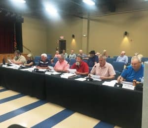 Pictured left to right: County Commissioners Myron Rhody, Susannah Cripps, Larry Green, Glynn Merriman, Daniel Cripps, Andy Pack, and Jeff Barnes.