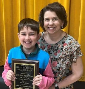 5th grade student Karson Mullinax was the recipient of the top reading award this year at DeKalb West School. DWS School Librarian Amanda Mullinax, who is also his mom, presented Karson with the Amanda Mullinax Librarian Award for earning the most Accelerated Reader points since starting at DeKalb West. He has earned 1,877.3 points in his school career, securing him a prestigious spot on the plaque in the school library.