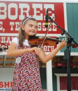 A Franklin girl won the top Jamboree award Saturday as the best fiddler in the National Championship for Country Musician Beginners. Ella Derby won the coveted James G. “Bobo” Driver Memorial Award, named for the man who started the children’s competition during the 1980’s as part of the annual Fiddler’s Jamboree and Crafts Festival. Members of Mr. Driver’s family presented the award to Derby.